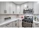 Modern kitchen featuring white cabinets, stainless steel appliances, and stylish countertops at 3104 Waterview Dr, Las Vegas, NV 89117