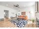 Open concept living room with hardwood floors, orange sofa, stylish rug, contemporary decor, and bright natural light at 3104 Waterview Dr, Las Vegas, NV 89117