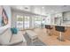 Inviting living room with hardwood floors, modern bar seating, white couch, outdoor view, and bright natural light at 3104 Waterview Dr, Las Vegas, NV 89117
