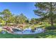 Community pond and water feature, with grass, trees, and a walking path at 3104 Waterview Dr, Las Vegas, NV 89117