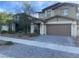 Two-story home with a neutral color palette, two-car garage, and desert landscaping at 330 Silva Pl, Henderson, NV 89011