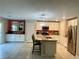 Open concept kitchen with stainless steel appliances and breakfast bar at 330 Silva Pl, Henderson, NV 89011