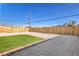 A spacious backyard featuring artificial turf, rock landscaping, and a wood fence at 333 Rossmoyne Ave, North Las Vegas, NV 89030