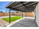 View of covered patio and artificial grass surrounded by low-maintenance rock landscaping at 333 Rossmoyne Ave, North Las Vegas, NV 89030