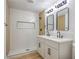 Elegant bathroom with double vanity, modern fixtures, and a beautifully tiled walk-in shower at 333 Rossmoyne Ave, North Las Vegas, NV 89030