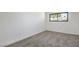 Bright bedroom with neutral carpet and a window offering a view of the outdoors at 333 Rossmoyne Ave, North Las Vegas, NV 89030