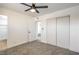 A bright bedroom featuring a ceiling fan, neutral-toned carpet, and a closet at 333 Rossmoyne Ave, North Las Vegas, NV 89030