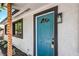 Close-up of the home's entry showcasing a stylish teal-colored front door and decorative exterior elements at 333 Rossmoyne Ave, North Las Vegas, NV 89030