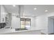 A well-lit kitchen with stainless steel appliances and an island overlooking the backyard at 333 Rossmoyne Ave, North Las Vegas, NV 89030