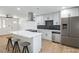 Modern kitchen featuring stainless steel appliances, sleek white cabinets, and a stylish island with seating at 333 Rossmoyne Ave, North Las Vegas, NV 89030