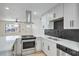 Modern kitchen showcasing stainless steel appliances, an island, and white cabinetry at 333 Rossmoyne Ave, North Las Vegas, NV 89030