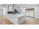 A modern kitchen island with ample counter space, and stainless appliances with a sliding glass door at 333 Rossmoyne Ave, North Las Vegas, NV 89030