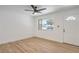 Bright living room with neutral paint, laminate floors, a large window, and a ceiling fan at 333 Rossmoyne Ave, North Las Vegas, NV 89030