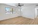 Bright living room with neutral paint, laminate floors, a large window, and a ceiling fan at 333 Rossmoyne Ave, North Las Vegas, NV 89030