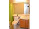 Bathroom featuring toilet, sink with wood cabinet, and shower with green curtain at 3519 W Red Coach Ave, North Las Vegas, NV 89031