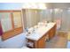 This bathroom has a double sink vanity with wood cabinets, mirror, and a shower at 3519 W Red Coach Ave, North Las Vegas, NV 89031