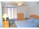 Bright bedroom featuring bed, dresser, nightstand, chair, and good natural light at 3519 W Red Coach Ave, North Las Vegas, NV 89031