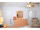 Bedroom with wood furniture set, ceiling fan, and convenient bathroom access at 3519 W Red Coach Ave, North Las Vegas, NV 89031