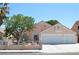 Charming single-story home boasts a well-manicured yard, two-car garage, and inviting curb appeal at 3519 W Red Coach Ave, North Las Vegas, NV 89031