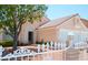 Charming single story home featuring a secure white decorative fence and a two-car garage at 3519 W Red Coach Ave, North Las Vegas, NV 89031