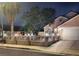 Single-story home boasts a well-manicured lawn, arched windows, attached two-car garage and decorative fence at 3519 W Red Coach Ave, North Las Vegas, NV 89031