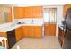 Spacious kitchen with ample cabinets, tile countertops, and a dishwasher creates a functional cooking area at 3519 W Red Coach Ave, North Las Vegas, NV 89031