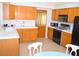 Bright and spacious kitchen with tile countertops, and ample cabinet storage; modern appliances for gourmet cooking at 3519 W Red Coach Ave, North Las Vegas, NV 89031