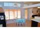 Bright kitchen and dining area featuring large windows, tile flooring, and a view of the backyard at 3519 W Red Coach Ave, North Las Vegas, NV 89031