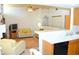 Open living area flows from kitchen, featuring comfortable seating and tile flooring at 3519 W Red Coach Ave, North Las Vegas, NV 89031