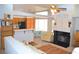 Open concept living area with fireplace, kitchen bar, and dining space at 3519 W Red Coach Ave, North Las Vegas, NV 89031