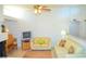 Bright living room features tile floors, ceiling fan, and comfortable seating arrangement at 3519 W Red Coach Ave, North Las Vegas, NV 89031