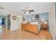 Bright bedroom features a wooden sleigh bed, ceiling fan, and adjacent bathroom access at 3753 Heritage Ave, Las Vegas, NV 89121