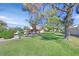Exterior view of a building with green lawn, trees, and a curved wall at 3753 Heritage Ave, Las Vegas, NV 89121