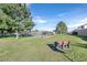 Exterior view of green lawn with mature trees and a bench at 3753 Heritage Ave, Las Vegas, NV 89121