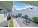 Private patio with BBQ, seating, and an artificial turf area at 3753 Heritage Ave, Las Vegas, NV 89121