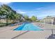 Community swimming pool featuring sparkling blue water, spacious deck, and mature trees at 3753 Heritage Ave, Las Vegas, NV 89121