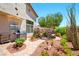 Beautiful backyard with stone pathways, lush landscaping, mature trees, and outdoor grill, ideal for outdoor living at 419 Alonzo Ct, Las Vegas, NV 89123