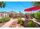 Secluded backyard with a paved patio, an outdoor grill, lush landscaping, and a storage shed, perfect for outdoor enjoyment at 419 Alonzo Ct, Las Vegas, NV 89123