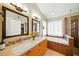 Bright bathroom with dual sinks, walk-in shower, and soaking tub at 419 Alonzo Ct, Las Vegas, NV 89123