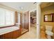 Bathroom with soaking tub, glass shower, and walk-in closet access at 419 Alonzo Ct, Las Vegas, NV 89123