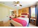 Cozy bedroom with mirrored closet, yellow walls, ceiling fan, and inviting decor creating a relaxing atmosphere at 419 Alonzo Ct, Las Vegas, NV 89123