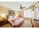 Neutral bedroom with wood bed frame, side tables, and large window at 419 Alonzo Ct, Las Vegas, NV 89123