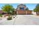 Inviting two-story home featuring a spacious three-car garage and mature desert landscaping in front yard at 419 Alonzo Ct, Las Vegas, NV 89123