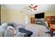 Comfortable living room with plush sectional, vaulted ceiling, fireplace, and built-in shelving for storage and display at 419 Alonzo Ct, Las Vegas, NV 89123