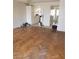 Bright living room with hardwood flooring that flows to the kitchen with white cabinets at 4231 White Sands Ave, Las Vegas, NV 89121
