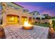 A stone patio with a fire pit and putting green make this backyard an entertainer's dream at 424 Vigo Port St, Las Vegas, NV 89138