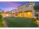 Beautiful backyard with an artificial turf, an outdoor firepit, and covered patio at 424 Vigo Port St, Las Vegas, NV 89138