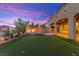Backyard boasts a putting green, a cozy fire pit, and manicured landscaping, perfect for outdoor entertaining at 424 Vigo Port St, Las Vegas, NV 89138