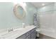 Bathroom with a large mirror, a white vessel sink, and a shower-tub combo at 424 Vigo Port St, Las Vegas, NV 89138