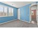 This blue bedroom features two windows with white shutters, gray carpet, and white trim at 424 Vigo Port St, Las Vegas, NV 89138